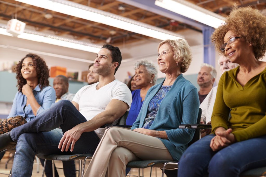 Group Attending Neighborhood Meeting In Community Center